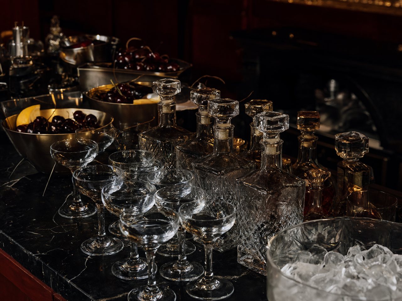 A brass and black marble cocktail station set before service