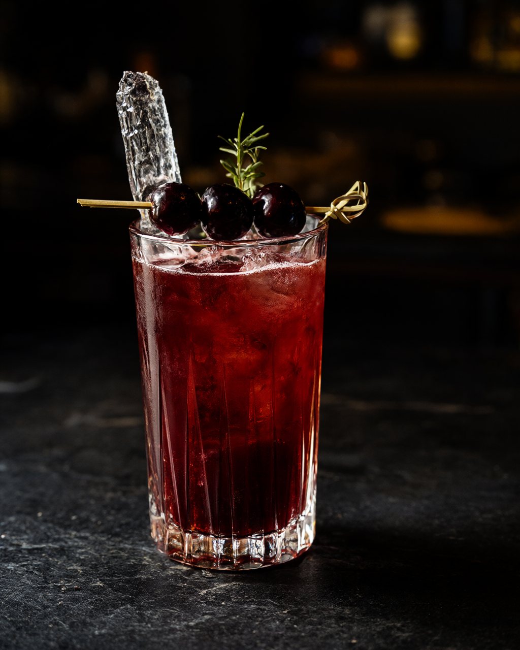 A garnet zero-proof cocktail with a cherry skewer